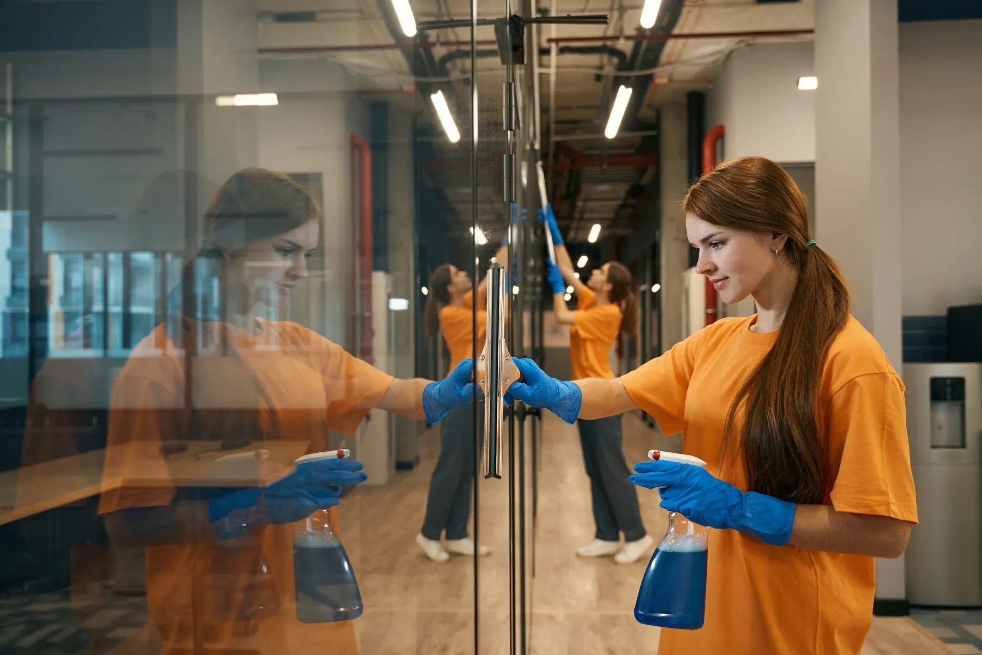Cleaners cleaning glass partitions in a Cambridge office